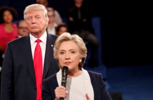 FILE PHOTO: Republican U.S. presidential nominee Donald Trump listens as Democratic nominee Hillary Clinton answers a question from the audience during their presidential town hall debate at Washington University in St. Louis, Missouri, U.S., October 9, 2016. REUTERS/Rick Wilking/File Photo